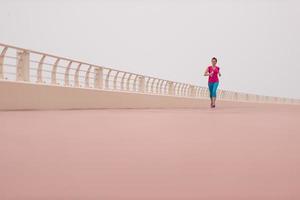 woman busy running on the promenade photo