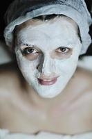 woman with facial mask in cosmetic studio photo