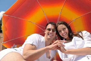 happy young couple have fun on beach photo