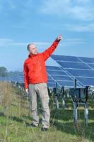 Male solar panel engineer at work place photo