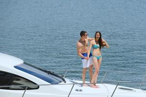 young couple on yacht photo