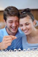 happy young couple in jewelry store photo