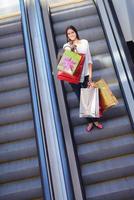 Happy young woman in a shopping mall photo