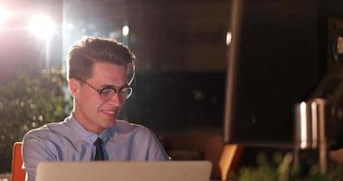 man working on computer in dark office photo