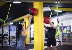 young athletes couple working out with medical ball photo