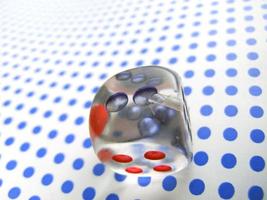 gamblig dice on blue dotted background photo