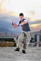 young man jumping in air outdoor at night ready to party photo