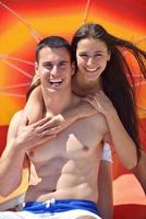 happy couple have fun on the beach photo
