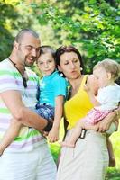 happy young couple with their children have fun at park photo