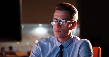 man working on computer in dark office photo