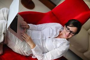 woman using a laptop computer at home photo