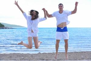 happy couple have fun on the beach photo