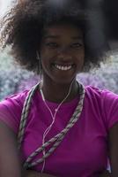 portrait of young afro american woman in gym while listening music photo