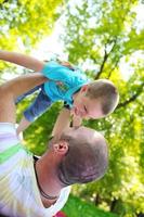 happy father and son have fun at park photo