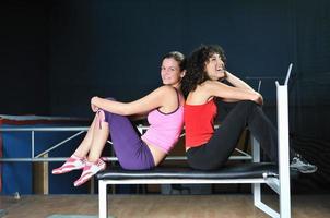 two women work out  in fitness club photo