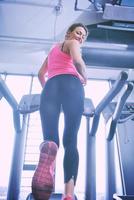 woman exercising on treadmill in gym photo