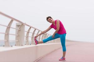 woman stretching and warming up on the promenade photo