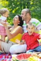 happy young couple with their children have fun at park photo