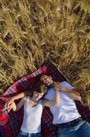 happy couple in wheat field photo