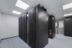 Data Center With Multiple Rows of Fully Operational Server Racks. Modern Telecommunications, Cloud Computing, Artificial Intelligence, Database, Supercomputer Technology Concept. photo