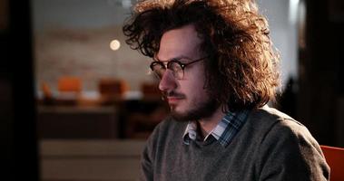 man working on computer in dark office photo