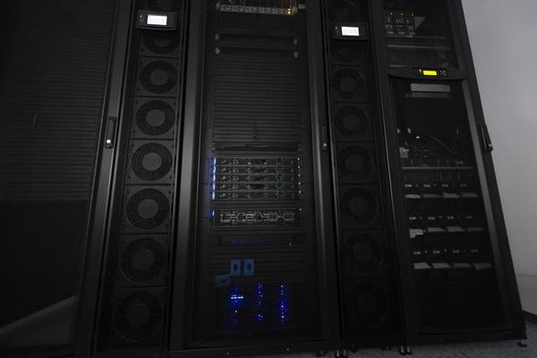 Data Center With Multiple Rows of Fully Operational Server Racks. Modern Telecommunications, Cloud Computing, Artificial Intelligence, Database, Supercomputer Technology Concept.