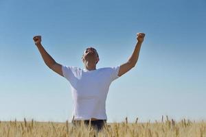 man in wheat field photo