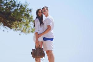 happy couple have fun on the beach photo