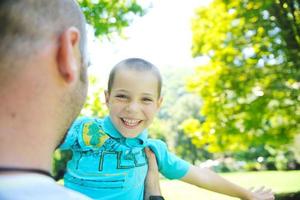 happy father and son have fun at park photo