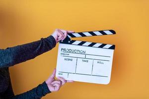 movie clapper isolated on yellow background photo