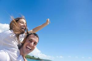 happy couple have fun on the beach photo