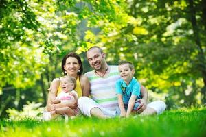 happy young couple with their children have fun at park photo