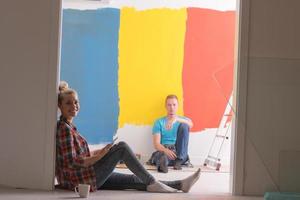 Happy young couple relaxing after painting photo