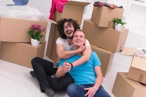 young  gay couple moving  in new house photo