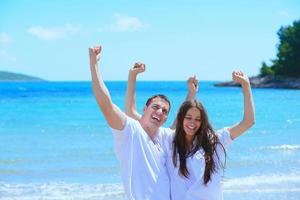 happy couple have fun on the beach photo