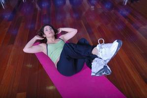 young pretty woman exercising in a fitness center photo