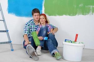 happy young cople relaxing after painting in new home photo