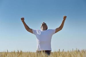 man in wheat field photo