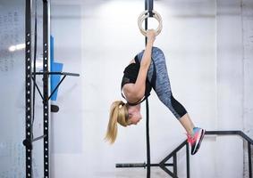 mujer trabajando en anillos de gimnasia foto