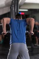 man doing exercises parallel bars photo