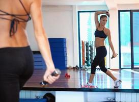 woman doing exercise with dumbbell photo