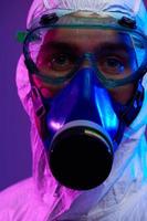 Doctor wearing protective biological suit and mask due to coronavirus photo