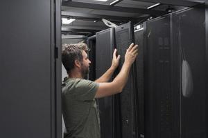 IT engineer working In the server room or data center The technician puts in a rack a new server of corporate business mainframe supercomputer or cryptocurrency mining farm. photo