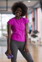 woman working out in a crossfit gym with dumbbells photo