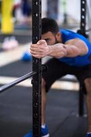 man doing pull ups on the vertical bar photo