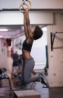 black woman doing dipping exercise photo