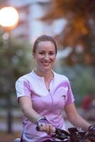 portrait of sporty woman with bike in park photo