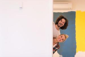 portrait of a couple painting interior wall photo