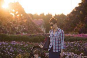 mother and daughter in flower garden photo