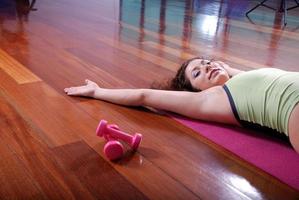 prety girl laying on back in fitness studio photo